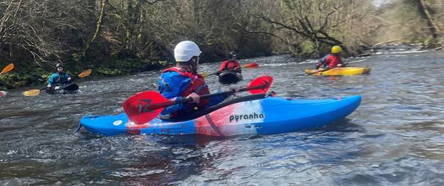 People kayaking on a river